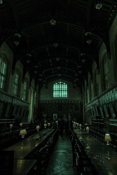 an empty dining hall with tables and chairs in the center, lit up by windows