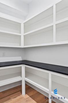 empty white shelves in the corner of a room