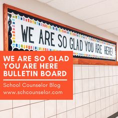 there is a bulletin board on the wall in this school hallway that says, we are so glad you are here bulletin board