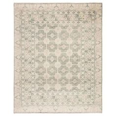 an antique rug with green and white designs on the bottom, in various sizes and colors