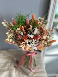 a bouquet of flowers sitting on top of a bed