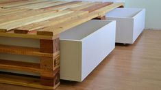 a table made out of wood and white drawers