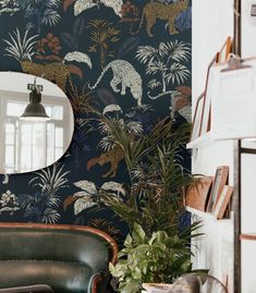 a living room with a chair and wallpaper