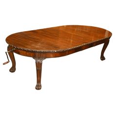 an oval wooden table with metal trimmings