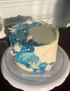 a blue and white cake sitting on top of a plate