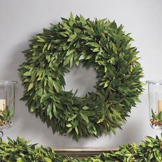 a fireplace decorated with greenery and candles