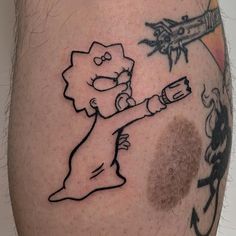 a man's leg with a cartoon character drawn on it and an airplane in the background