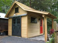 a small wooden shed with a red door