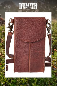 a brown leather bag with two straps on it and the words, dultth trading