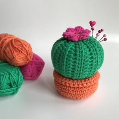 three crocheted balls of yarn are sitting next to each other on a white surface