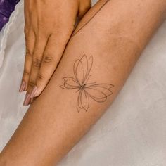 a woman's arm with a tattoo on it and a flower in the middle