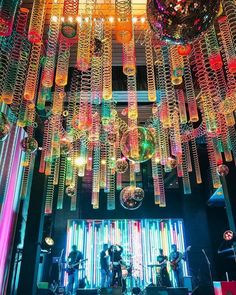 a large chandelier hanging from the ceiling in a room filled with disco balls