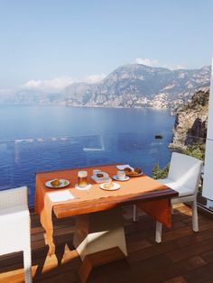 the table is set on the deck overlooking the ocean