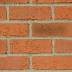 an orange brick wall is shown in this close up shot, with the corner section missing