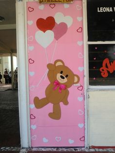 a door decorated with hearts and a teddy bear