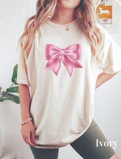 ABOUT OUR Bow Ribbon Coquette Shirt Enjoy fashion with our Coquette Shirt. This T-shirt is perfect as a cute gift or Daughter Gift. This is a Ribbon Shirt, especially for those who want to be fashionable and, at the same time, have a cute and nice look Look no further! This trendy Coquette Bow Ribbon Shirt is unique and practical for Girls, Daughter or Moms, combining style and utility. 👉 Unisex T-shirt - 100% Airlume combed and ringspun cotton  - Soft cotton and quality print make users fall i Coquette Shirt, Shirt Coquette, Aesthetic Gift, Ribbon Shirt, Bow Ribbon, Cottagecore Aesthetic, Coquette Bow, Gift For Daughter, Cute Gift