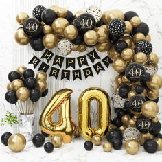 black, gold and white balloons surround the number forty balloon arch