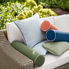 some pillows are sitting on a couch outside