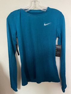 Nike Medalist Running Women Long Sleeves Top Blue 928939 317 100% Authentic, Brand New with tag Women Size Small Product Details: Slim FIt Nike Dry fabric helps you stay dry, comfortable and focused. Engineered knit is ultra-lightweight and quick drying. Thumbholes help secure the sleeve cuffs and add warmth. Gradient fabric kicks your style into high gear. Hem hits just above the hips for comfortable coverage. Material: Dri-fit 100% Polyester ____________________________________________________ Sleeves Top, Women Long Sleeve Tops, Active Wear Tops, Running Women, Dri Fit, Long Sleeve Tshirt Men, Top Shirt, Long Sleeve Tops, Active Wear