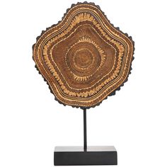 an intricately designed wooden plate on a stand