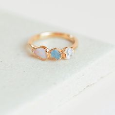 "★ This item is made to order. Please check the shipping section for current processing times. OPAL AQUAMARINE QUARTZ RING A dainty opal ring with raw aquamarine and quartz stones. Low-key enough for everyday, and fancy enough for those special moments. ⬥ THE LITTLE DETAILS * One opal ring * Width of ring band is 1.5mm * Every stone varies slightly * Hand formed rings do fit snug, size up if between sizes! * Ethically sourced stones * Lightly textured ring band * Heavy nickel-free 14k gold plate Dainty Opal Ring, Textured Ring Band, Opal Stacking Ring, Rough Quartz, Alternative Wedding Rings, Raw Aquamarine, Antique Engagement Ring, Opal Ring Gold, Engagement Ring White Gold