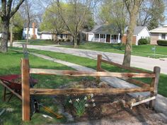 a wooden fence sitting in the middle of a yard