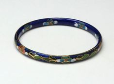 -Vintage Cloisonné bangle bracelet pair, one has a dark blue base the other has a black base-Cloisonné patterns are on both out outside and inside of each bangle-No makers marks-Great vintage condition: the blue base has minimal markings to the enamel; the black base has a few markings to the enamel on close inspection-Bangle size: 8", each-Width: black-a hair under 1/4"; blue-a hair over 1/4"-Depth: 3/16", each-Weight: black-18.3g; blue-19.5g-Add this pair of beautiful vintage dark blue and bla Vintage Blue Enamel Bracelets, Blue Enamel Bangle Gift, Blue Enamel Bangle As A Gift, Blue Enamel Bangle Perfect As A Gift, Blue Enamel Bangle Bracelets, Handmade Blue Enamel Bracelets, Blue Enamel Bangle Bracelet, Blue Enamel Bangle, Treble Clef Jewelry