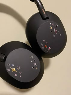 two black headphones with stars on them