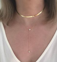 DETAILS MATERIAL - 925 Sterling Silver 18K Gold plated (1 micron) CHAIN LENGTH CHOKER TOTAL 35cm/14in Adjustable can be worn from 30cm/12in to 35cm/14in NECKLACE TOTAL 43cm/17in Adjustable can be worn from 38cm/15in to 43cm/17in CHAIN WIDTH - 5mm/0.20in CHAIN STYLE - SNAKE DESCRIPTION This elegant choker necklace features a flat herringbone chain with 5mm/0.20in width. It shimmers beautifully at every turn. It fastens with a lobster clasp. The chain is adjustable Available in 925 Sterling Silver Trendy Gold Jewelry 2024, Figaro Chain Lariat Jewelry As Gift, Herringbone Choker Necklace With Delicate Chain, Minimalist Figaro Chain Choker Jewelry, Gold Herringbone Choker Necklace With Delicate Chain, Minimalist Figaro Chain Choker, Gold Minimalist Herringbone Choker, Chic Gold Herringbone Choker, Gold Herringbone Chain Choker