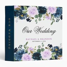 a wedding album with blue and pink flowers on the front, is shown in this image