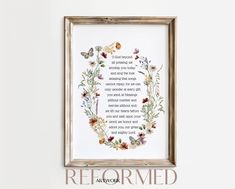 a framed art print with a poem in the center and butterflies around it, on a white wall