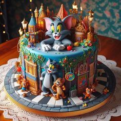 a birthday cake decorated with cartoon characters and lights