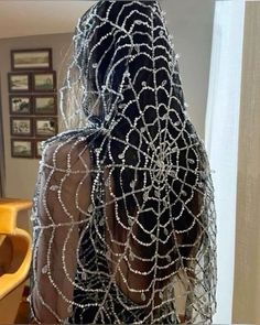 the back of a woman's head covered in chains