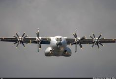 an airplane is flying in the sky with propellers on it's wings and wheels