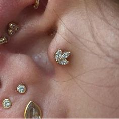 a close up of two ear piercings with diamonds on them