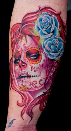 a woman's face with roses on her head and the words, day of the dead