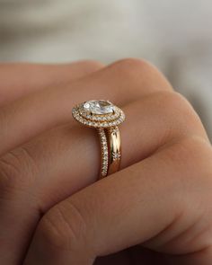 a woman's hand holding an engagement ring