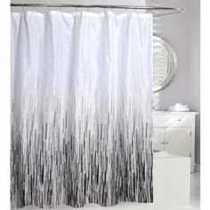 a shower curtain with black and white stripes on the bottom, in front of a mirror