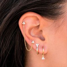 a close up of a person's ear with two piercings attached to it