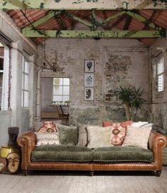 a living room filled with furniture and lots of windows