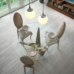 an aerial view of a dining room table with chairs and plates on the glass top