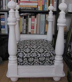 a white chair with a black and white seat cover in front of bookshelves