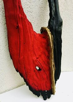 a piece of wood that is red and black