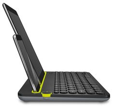 an open laptop computer sitting on top of a desk next to a yellow cup and saucer