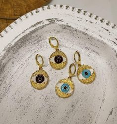 hoop earringsgold hoop earringsdangle earringshuggie hoop earringsclip on earringsgold evil eyeevil eye earringsgold earringsdrop earringsgift for hervintage earringsstatement earringseye earringsGold evil eye hoop earringsThis cute earrings are made from steell and they are 24k gold plated and handpainted.You can choose between 4 different clasps (the numbers 1 and 2 are for non pierced ears)They are very light and comfortable!Plus they are anti allergic/ nickel free ❤Evil eye meaningThe evil e Trendy Handmade Gold Plated Jewelry, Gold Evil Eye Drop Earrings, Trendy Gold Plated Teardrop Jewelry, Trendy 14k Gold-filled Dangle Jewelry, Tarnish Resistant Metal Dangle Clip-on Earrings, Tarnish Resistant Adjustable Drop Earrings, Metal Evil Eye Jewelry, Gift Small Hoop Clip-on Earrings Tarnish Resistant, Evil Eye Hoop Earrings As A Gift