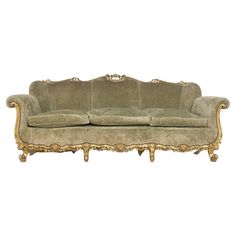 an old fashioned couch with gold trimmings on the arms and back, sitting in front of a white background