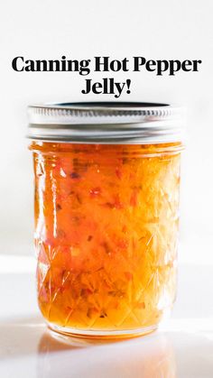 canning hot pepper jelly in a jar with text overlay that reads canning hot pepper jelly