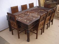 a wooden table with chairs around it