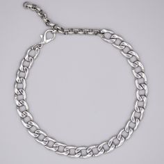 A Classic Chunky minimalist stainless steel Cuban Link Choker 12mm Width Stainless Cuban Chain 4 Inch 7mm Stainless Steel Adjuster Chain Non Tarnish Hypoallergenic Hand Made in the UK Sizing: Small 11 - 15 Inches (28cm - 38cm) Medium 13 - 17 Inches (33cm - 43cm) Large 15 - 19 Inches (38cm - 48.5cm)