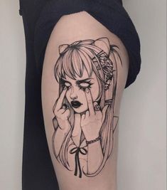 a woman's thigh with a drawing of a girl covering her eyes and holding her hand to her face